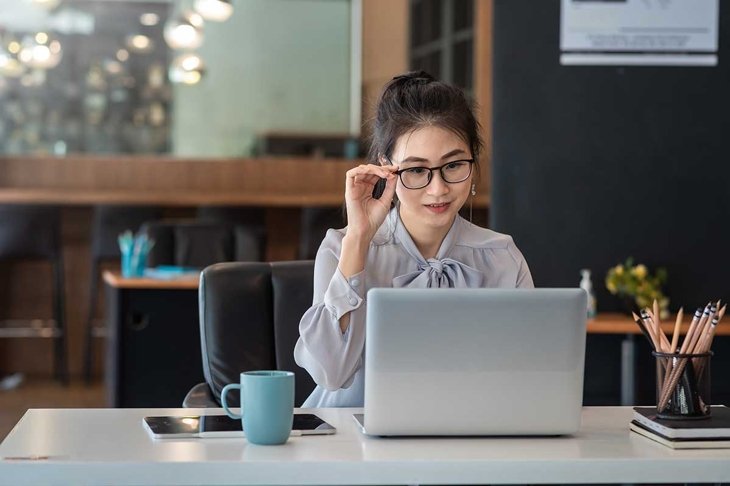 Asian Businesswoman working on laptop at her desk at the office.