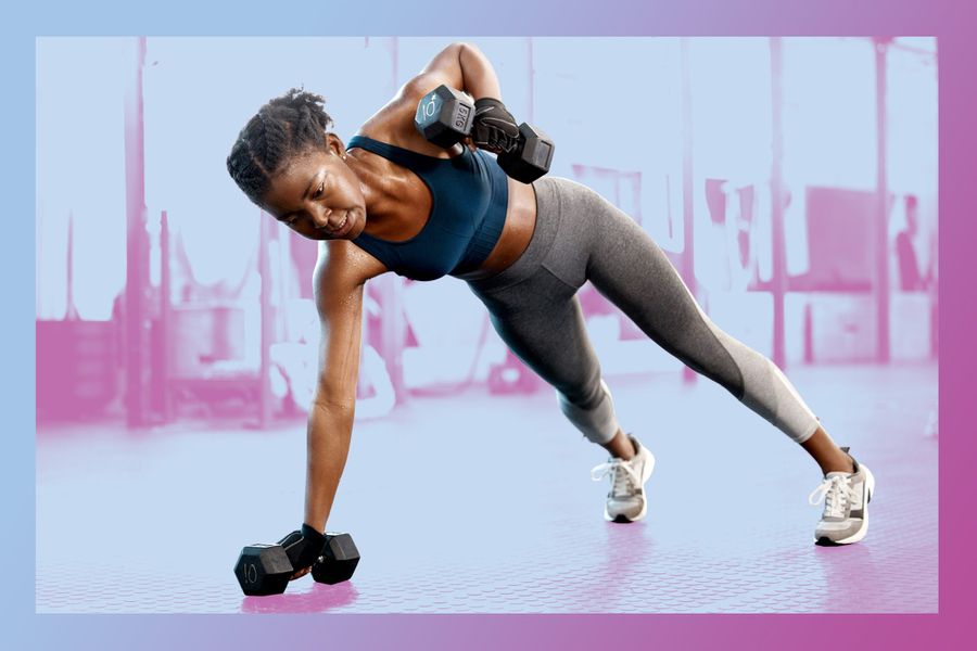 Shot of a sporty young woman doing planks with dumbbells in a gym