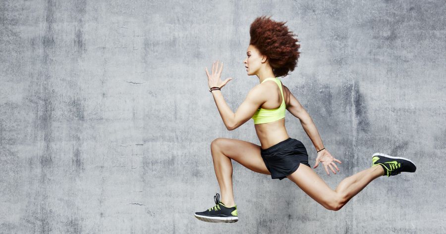 Woman jumping in air in urban studio