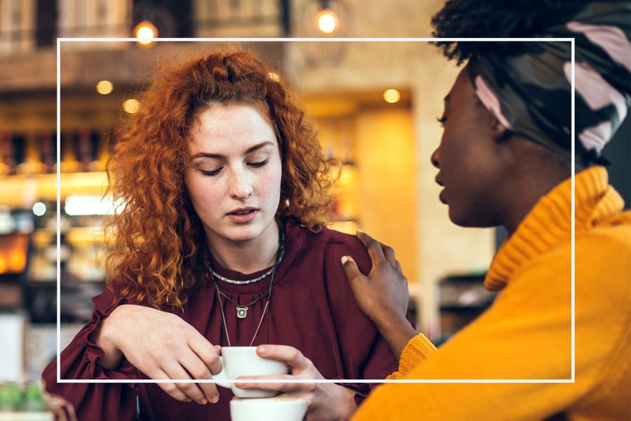 woman talking with supportive and understanding friend about her problem in a cafe