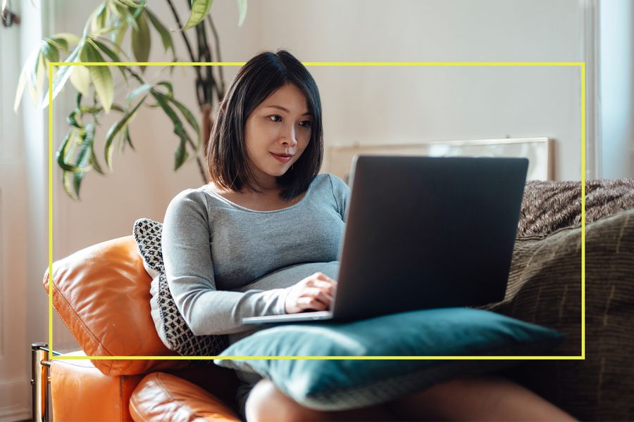 Woman Using Laptop on Couch