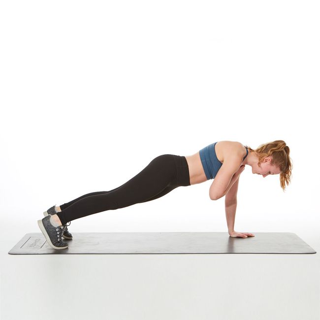 are planks good for abs? instructor demonstrating how to do a straight-arm plank with shoulder taps plank exercise