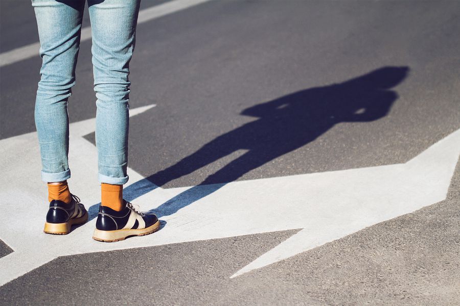 Woman Standing at a Crossroads