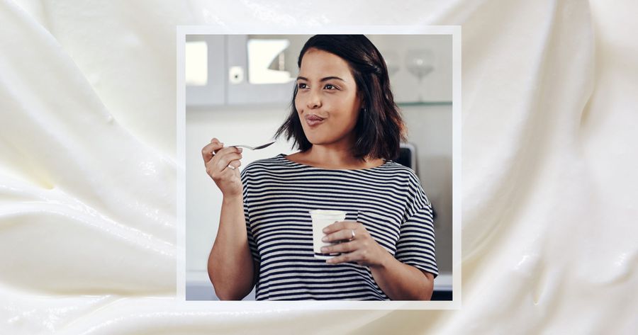 Woman_Eating_Yogurt_With_Background_That_Looks_Like_Greek_Yogurt