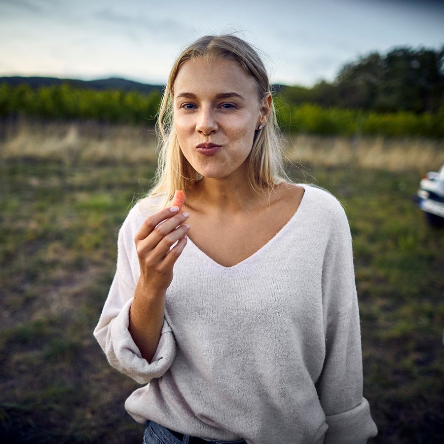 Woman eating carrot